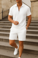 Person wearing a white outfit standing on stone steps.