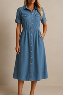 Woman wearing a blue denim dress against a beige background