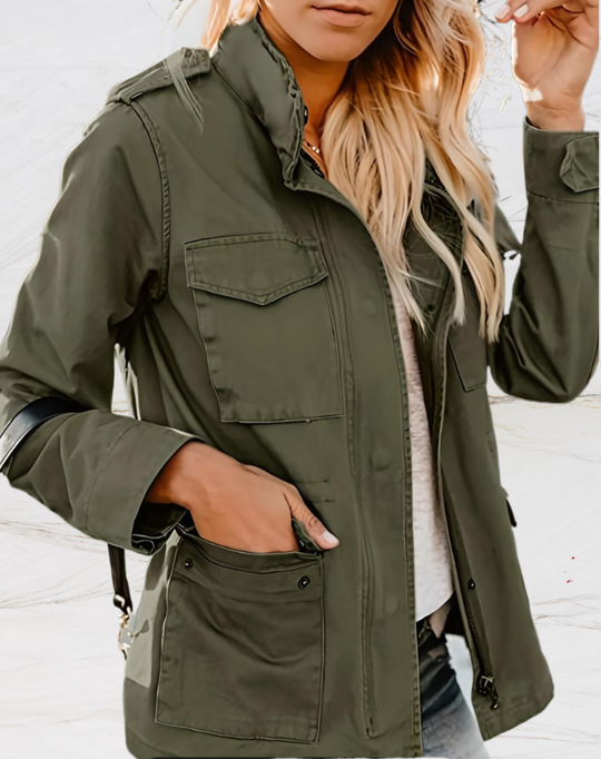 Person wearing a green jacket with a neutral background