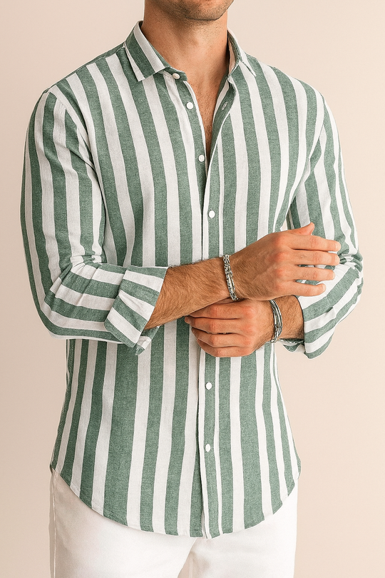 Man wearing a green and white striped shirt against a beige background
