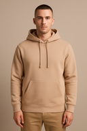 Man wearing a beige hoodie on a beige background