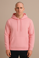 Man wearing a pink hoodie against a beige background