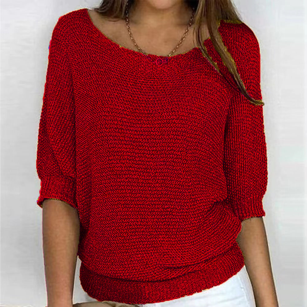 Red knitted sweater worn by a person on a white background