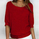 Red knitted sweater worn by a person on a white background