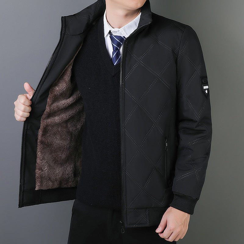 Person wearing a black quilted jacket with a gray background