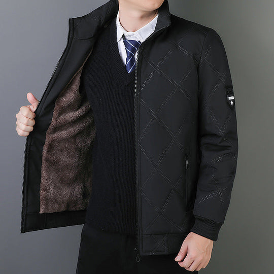 Person wearing a black quilted jacket with a gray background