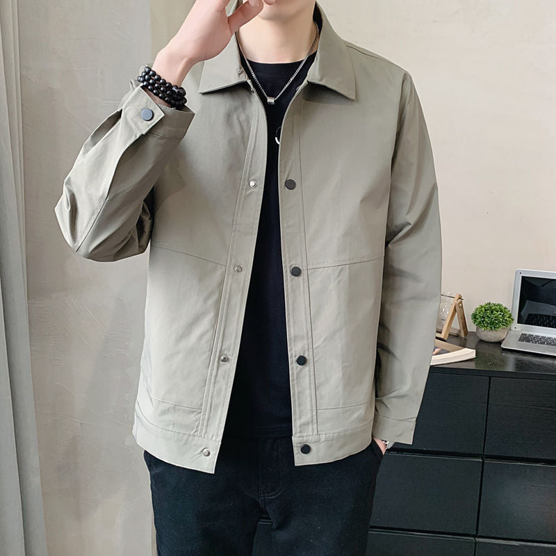 Person wearing a light gray jacket indoors with a neutral background