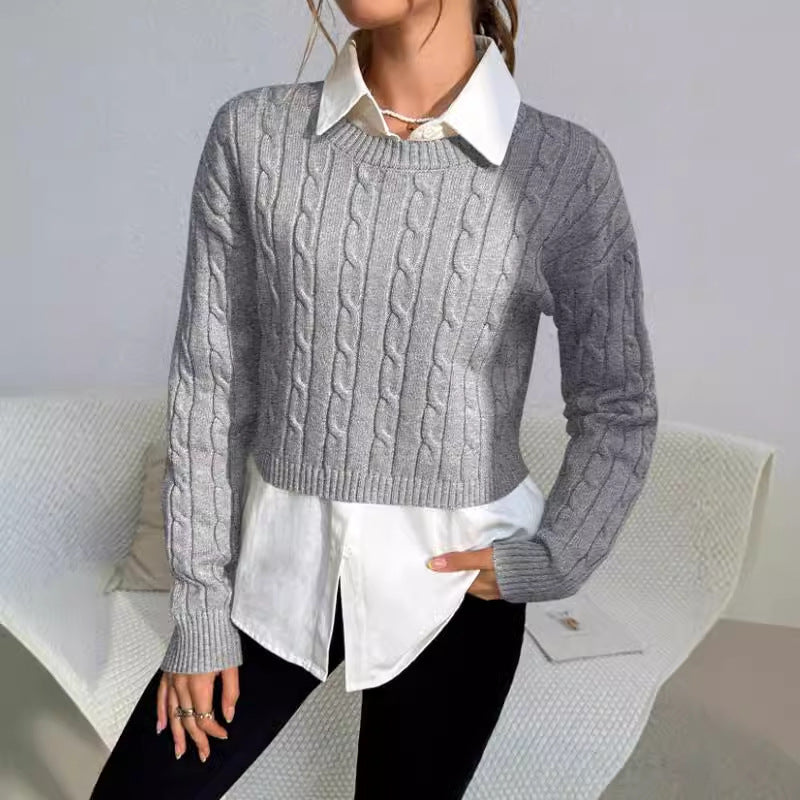 Person wearing a gray cable knit sweater over a white shirt with a neutral background