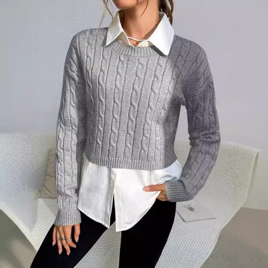 Person wearing a gray cable knit sweater over a white shirt with a neutral background