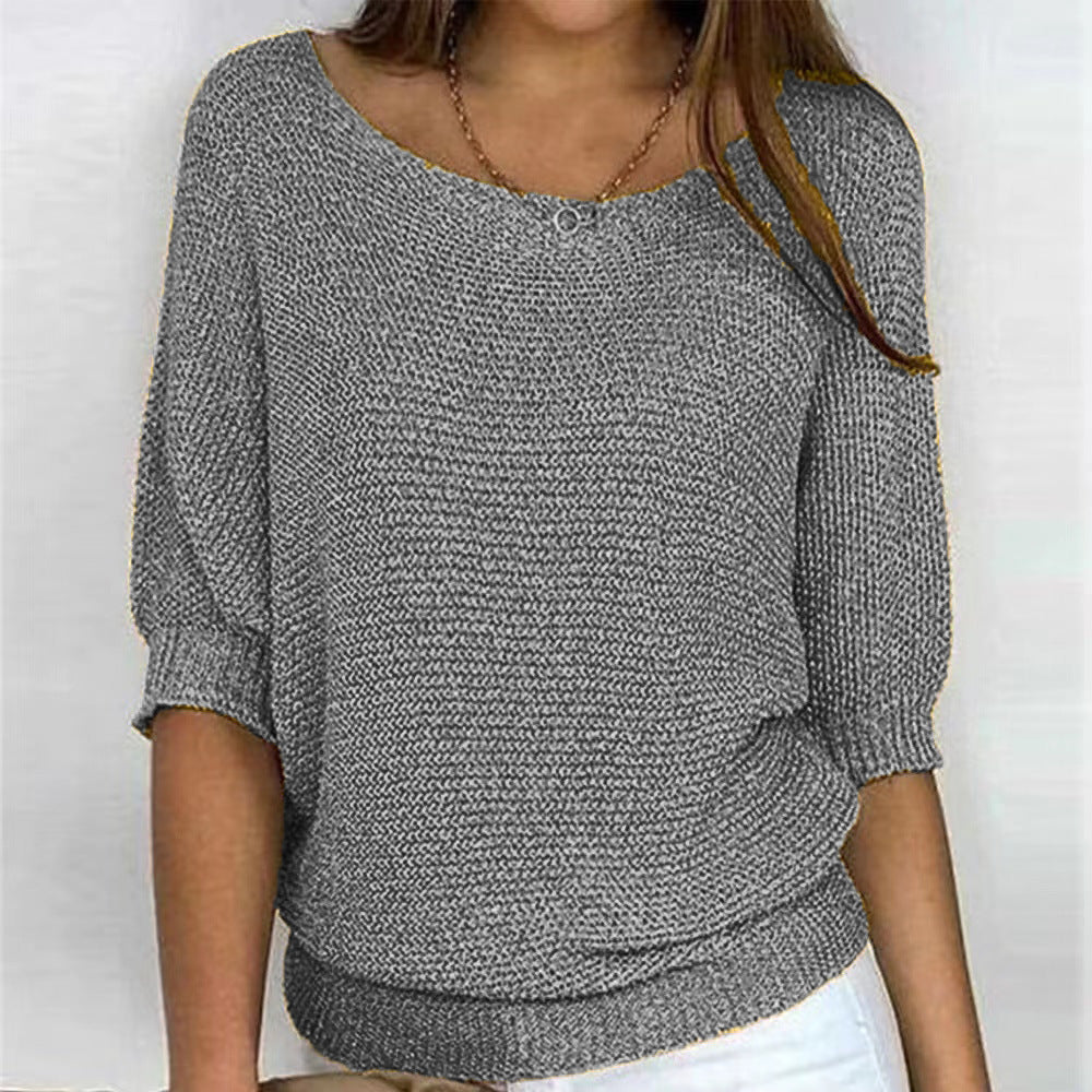 Person wearing a gray textured sweater on a white background