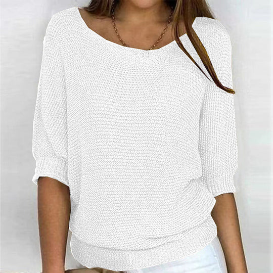 White textured top worn by a person on a plain background