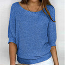 Blue knitted sweater worn by a person on a white background