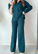 Person wearing a teal outfit with a white background