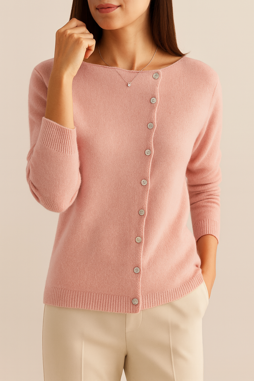 Woman wearing a Pink cardigan against a beige background