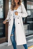 Person wearing a long beige coat in an urban setting