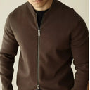 Brown zip-up jacket worn by a person on a plain background