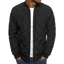 Black quilted jacket worn by a person on a white background