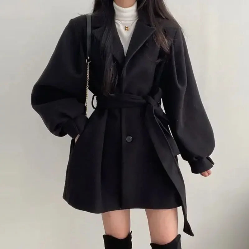 Person wearing a black coat with a white background