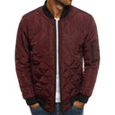 Maroon quilted jacket worn by a person on a white background
