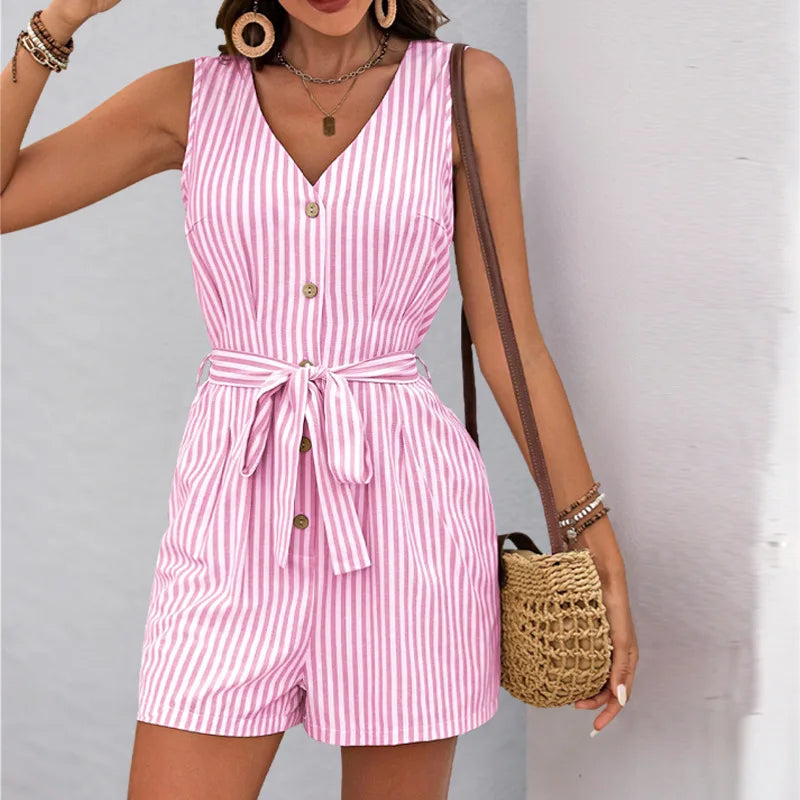 Woman wearing a pink and white striped romper with a plain background