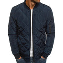 Navy quilted jacket worn by a person on a white background