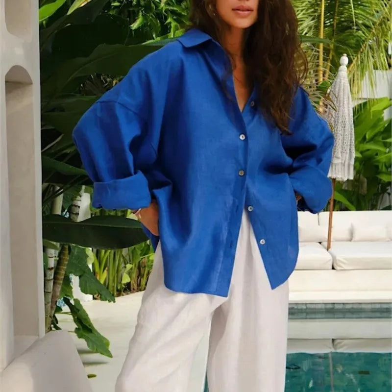 Person wearing a blue shirt and white pants in a tropical setting
