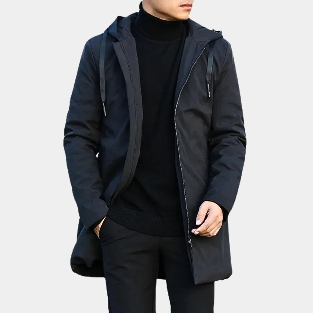 Person wearing a black jacket with a hood on a light gray background