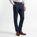 Navy blue dress pants with a white shirt and brown shoes on a light gray background
