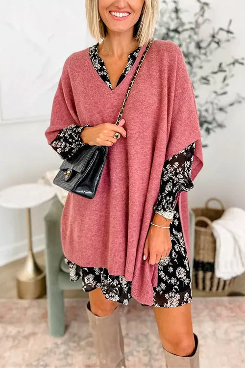 Woman wearing a pink dress with floral sleeves in a home setting