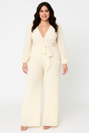 Woman wearing a cream jumpsuit on a white background