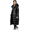 Woman wearing a long black puffer coat on a white background
