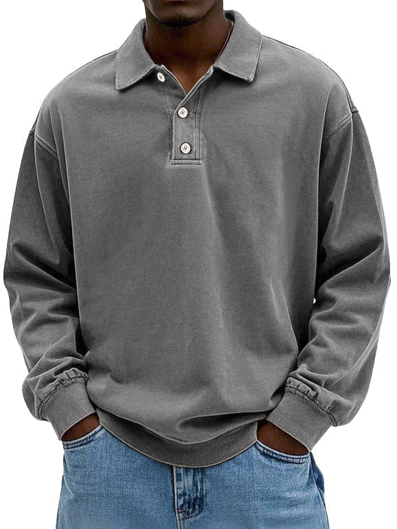 Person wearing a gray long-sleeve polo shirt with a white background