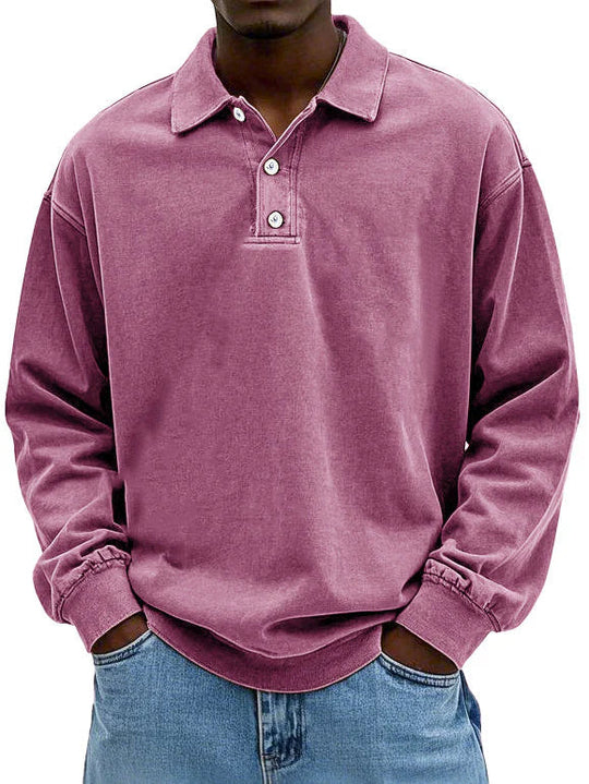 Person wearing a purple long-sleeve polo shirt with a white background