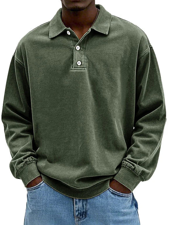 Person wearing a green long-sleeve polo shirt with rolled-up sleeves on a white background
