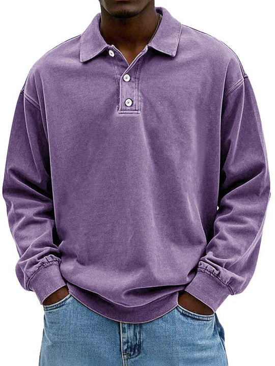 Person wearing a purple long-sleeve polo shirt with a white background