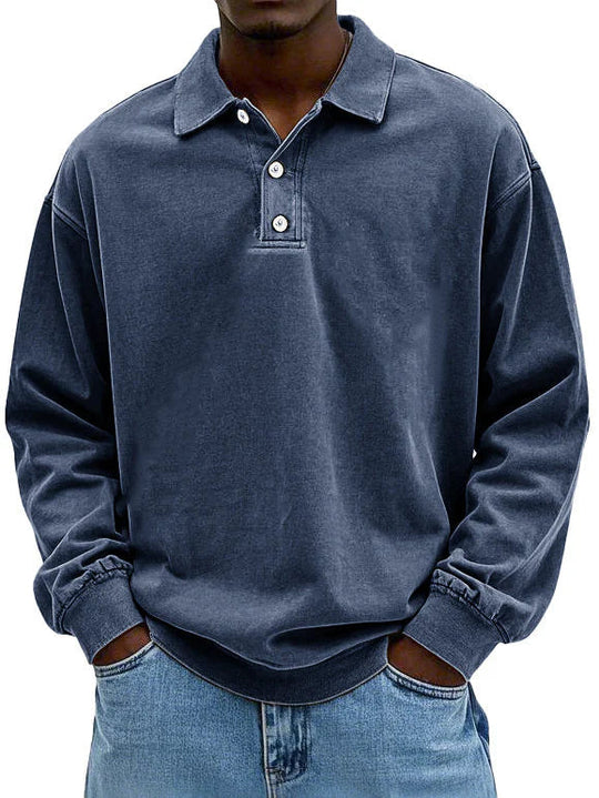 Person wearing a blue long-sleeve polo shirt on a white background